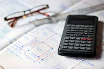 Calculator and building plans. Building planes for a new house, isolated.