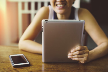 Asian woman using tablet computer . soft Focus on tablet.