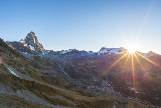 Aerial view at sunrise of Breuil Cervinia village  and Cervino or Matterhorn mountain peak, famous ski resort in Aosta Valley, Italy.