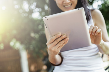 Asian woman using tablet computer . soft Focus on tablet.