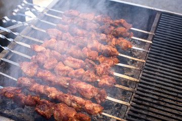 Meat skewers preparing on a barbecue grill