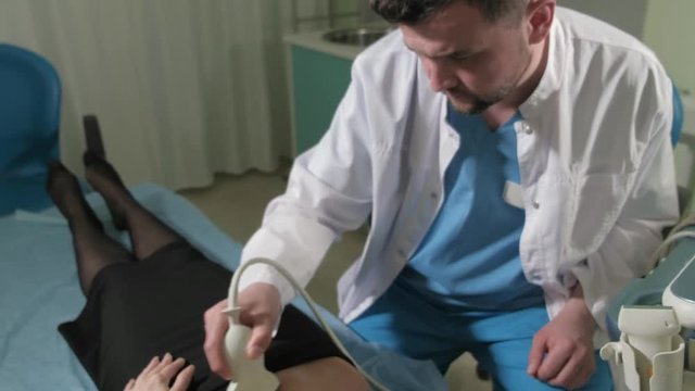 Doctor doing 3d ultrasound on belly of t woman in clinic 4k