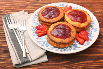 Cottage cheese patties with strawberry jam.