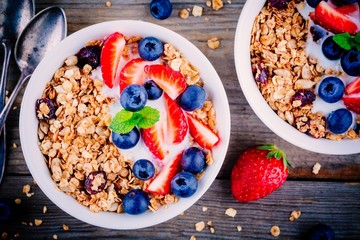 Healthy breakfast: bowl of granola with yogurt and berries