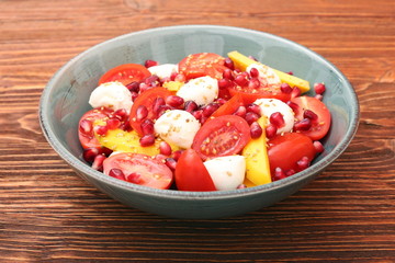 Tomato salad, mango and mozzarella with pomegranate seeds