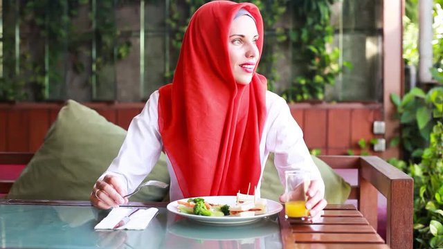 Muslim beautiful woman having lunch