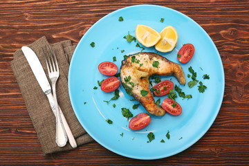 Steak of sturgeon with lemon and tomatoes