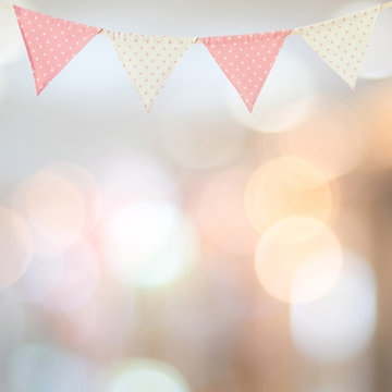 Bunting party flag on blur abstract bokeh light background, with copy space for text, holiday concept background