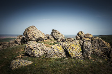 Rocks formations in Dobrogea, Tulcea county, Romania. Naturally formed piles of large rocks in Macin Mountain the olders alps in Europe