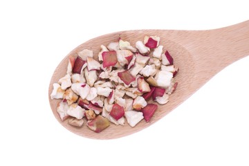 Dehydrated apple flakes in wooden spoon