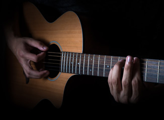 Fototapeta na wymiar Young man playing a guitar.