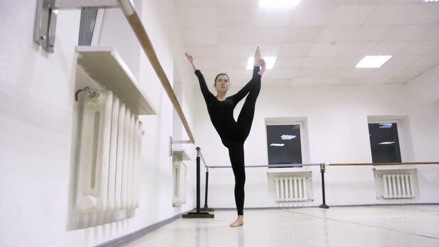 graceful girl practicing ballet in the Studio, slow motion , does pirouettes