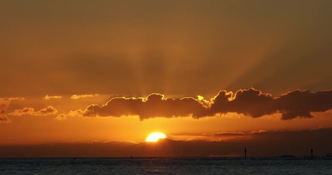 Sun over the Pacific Ocean shore of Waikiki beach in Honolulu, Oahu, Hawaii