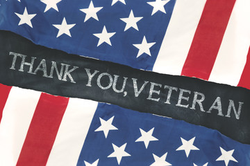 Fototapeta na wymiar American flags with handwriting of thank you, veteran