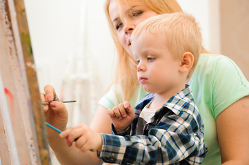 Mother and child draw a picture paints, art lesson