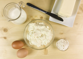 Bechamel in a transparent bowl on wooden background - top view