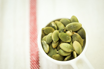 pumpkin seeds in plastic bowl, good grain for health