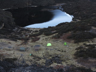 Green tent near lake