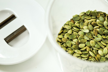 pumpkin seeds in plastic bowl, good grain for health