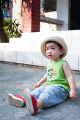 Toddler boy in green vest