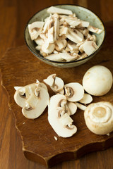 Champignon mushrooms on the wooden table. Selective focus