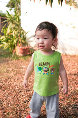 Toddler boy in green vest