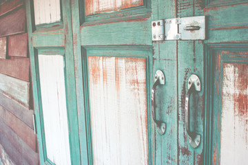 Green asian ancient wooden slide door with handle and keylock. The ancient door for back to the past.