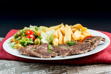 juicy steak beef meat with tomato and french fries