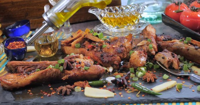 Pouring olive oil over delicious braised sticky king pork ribs