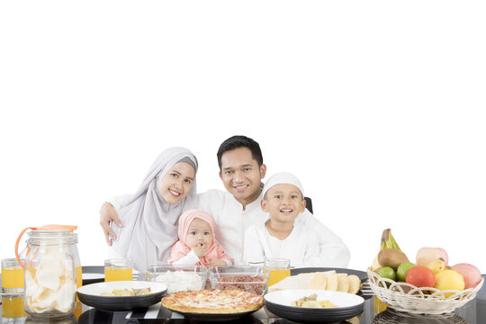 Muslim Family Having Meal At Dining Table