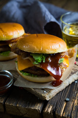 Hamburgers and beer on a wooden table