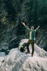 sportive male hiker trekking with backpack in the forest