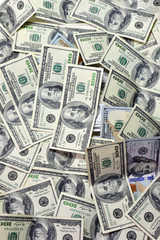 One hundred dollars pile as background.