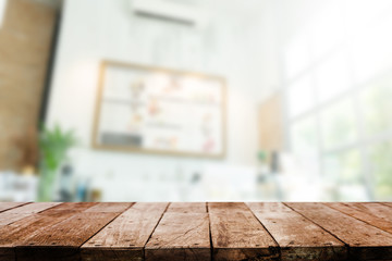Wood table top with coffee shop blurred background 