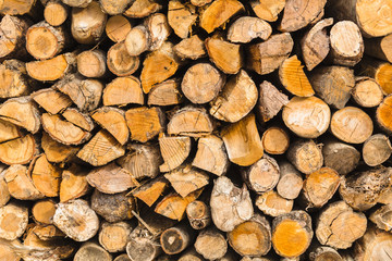 detail of pile of natural wooden logs texture background