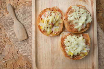 Mini pizza buns topped with mayonnaise sauce