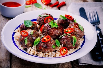 homemade meatballs with wild rice, mint, green onions and chili sauce