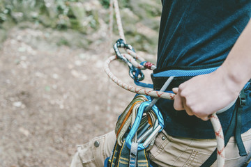 Climber belaying with figure eight.