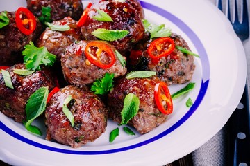 homemade meatballs with mint, green onions and chili sauce