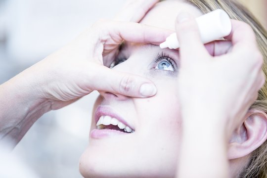 Person applying eye drops