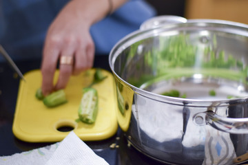 Woman chopping jalapeno peppers