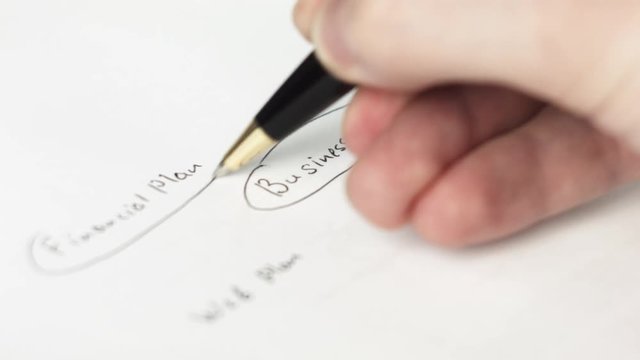 Man drawing business chart for presentation on white paper