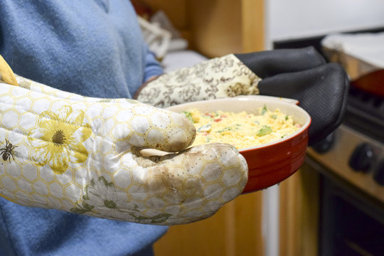 Woman With Oven Mitts Holding