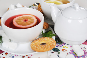 Delicious light breakfast in white ceramics with light tea with cookies