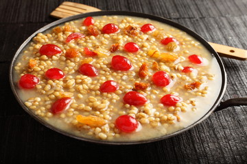 Delicious Homemade  sweet Wheat porridge served in wooden table 