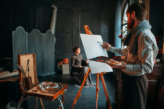 Painter drawing portrait against female poseur