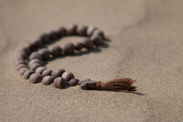 A wooden cross lies on the sand