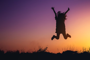 umbrella girl silhouette at sunset on  vintage  backdrop