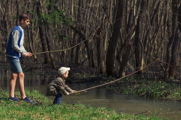 Obraz na płótnie Canvas Two brothers, friends, playing the Creek, boys in the beautiful surroundings