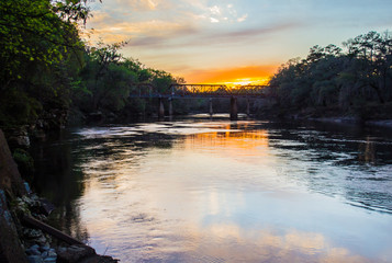 Train bridge over the Suwanee River at sunset.